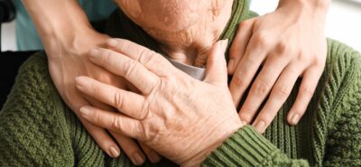 Attic Angel resident in a green, knit sweater