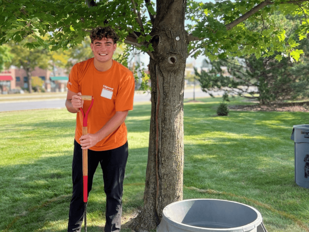 young man working out doors with shovel as a volunteer