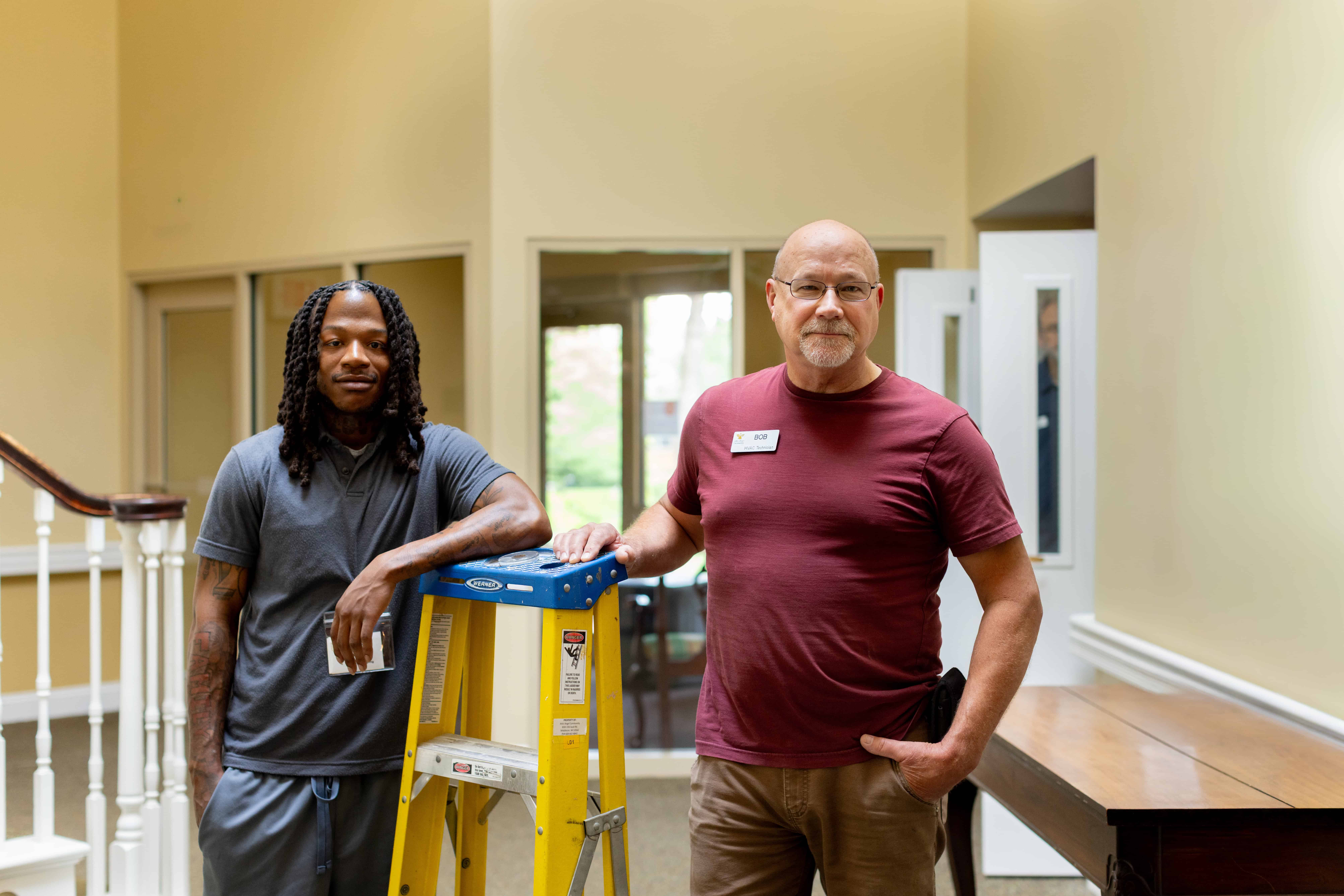 housekeeper and maintenance technician posing for picture